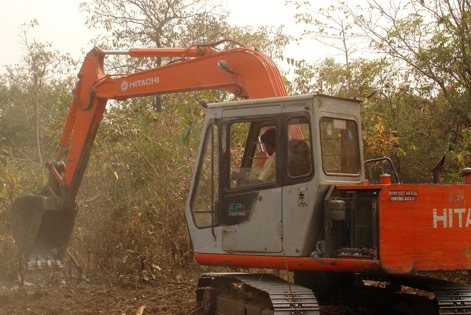 Orange Hitachi tracked excavator digging on canal work in Telangana