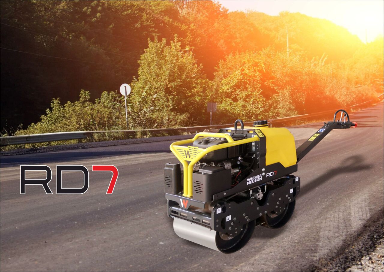 RD7 walk-behind roller on an asphalt road beside a guard rail